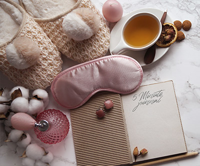  slippers, sleeping mask, relaxing tea, journal and candles