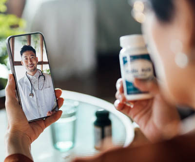 Woman having a video call with her doctor asking a question about a prescription